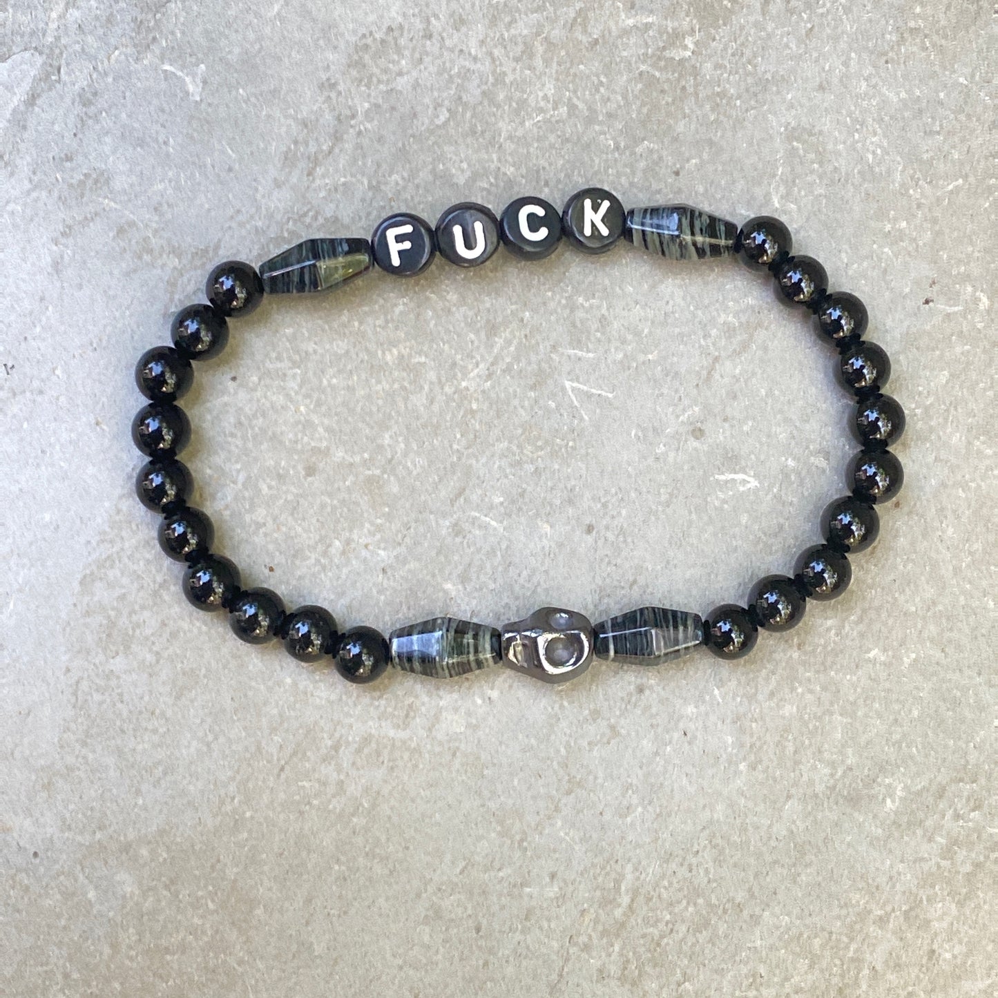 Men’s silver smoke jasper, onyx, and hematite skull "Curse" stretch bracelet