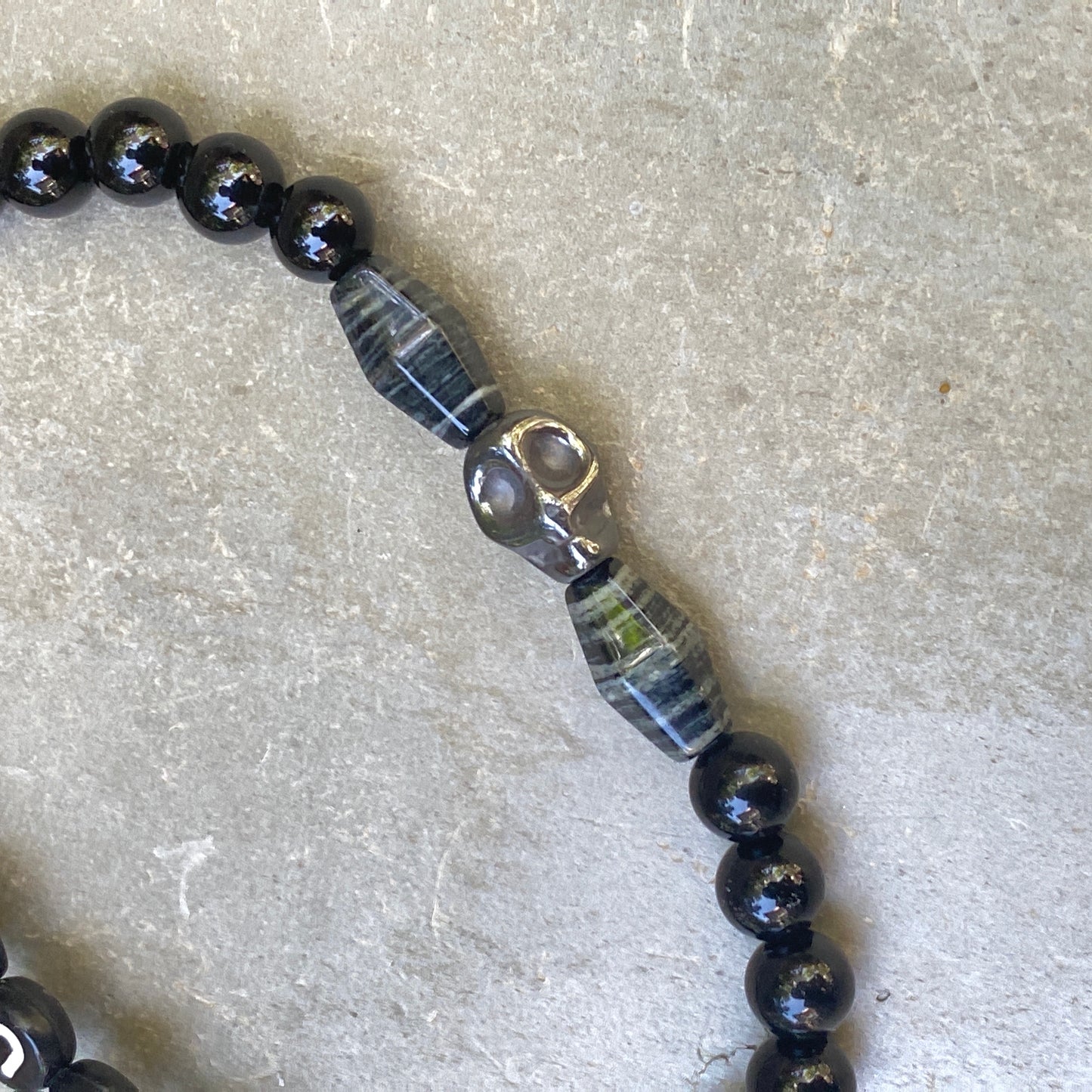 Men’s silver smoke jasper, onyx, and hematite skull "Curse" stretch bracelet