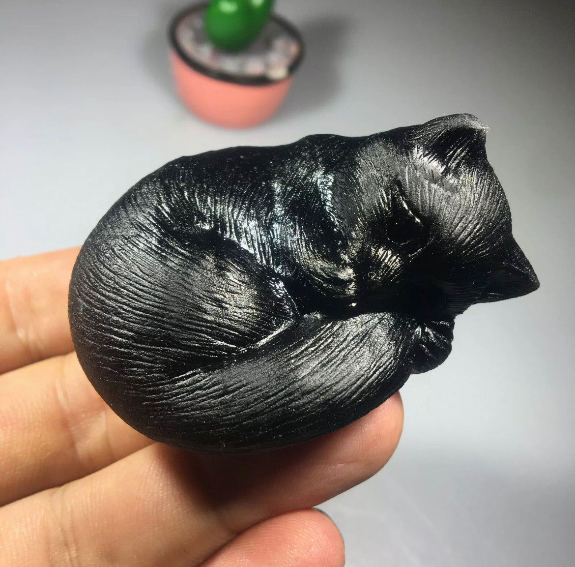 Black obsidian gemstone carved sleeping kitty cat