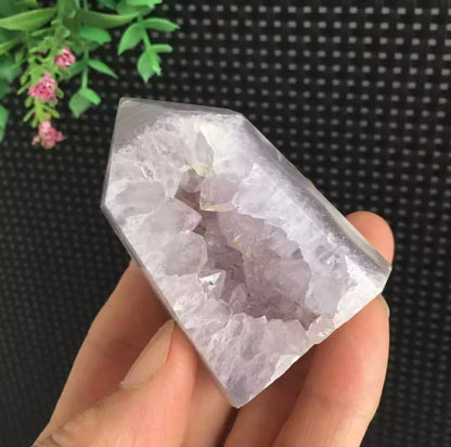 Amethyst geode inside purple agate tower