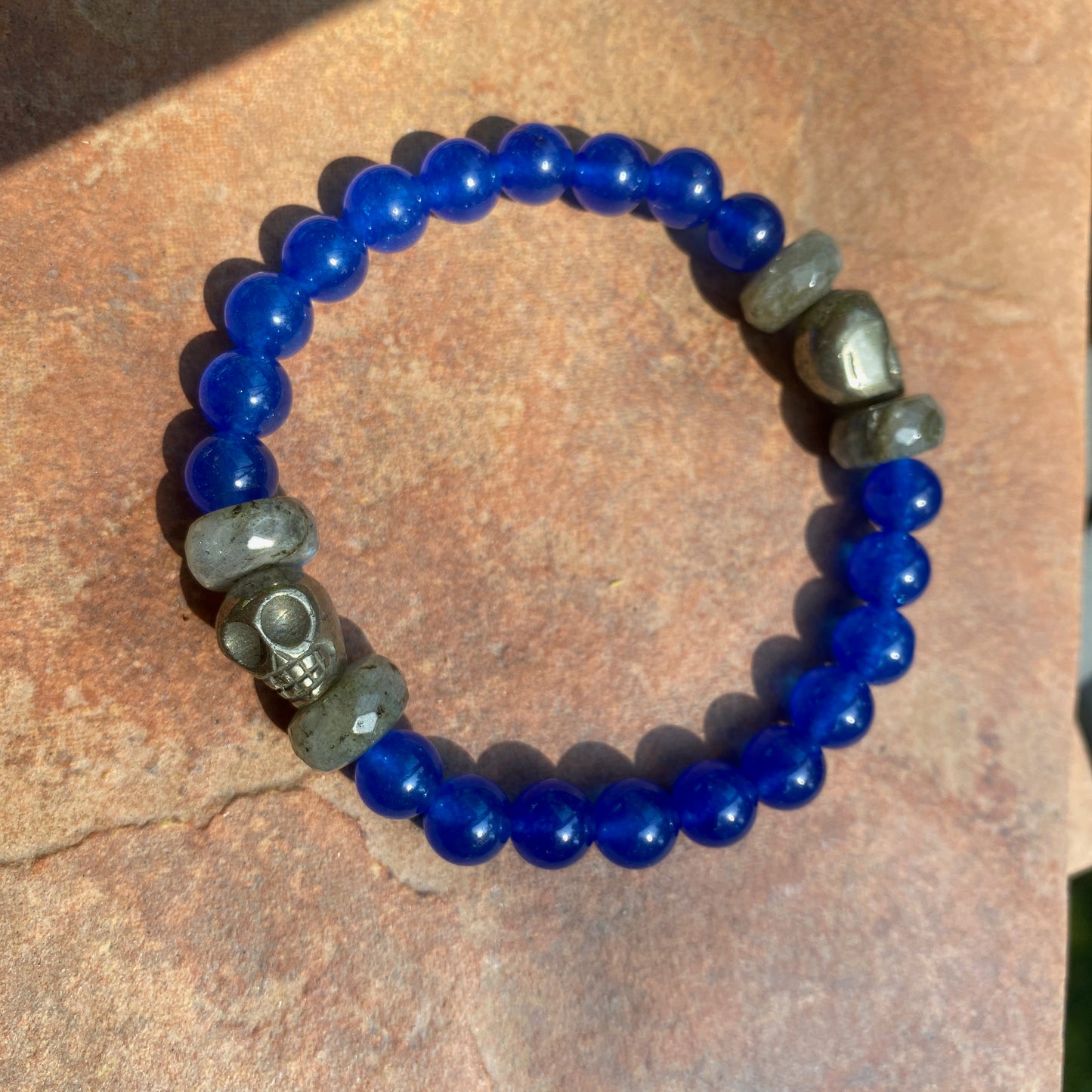 Men’s Blue onyx, pyrite skulls, and labradorite gemstone stretch bracelet