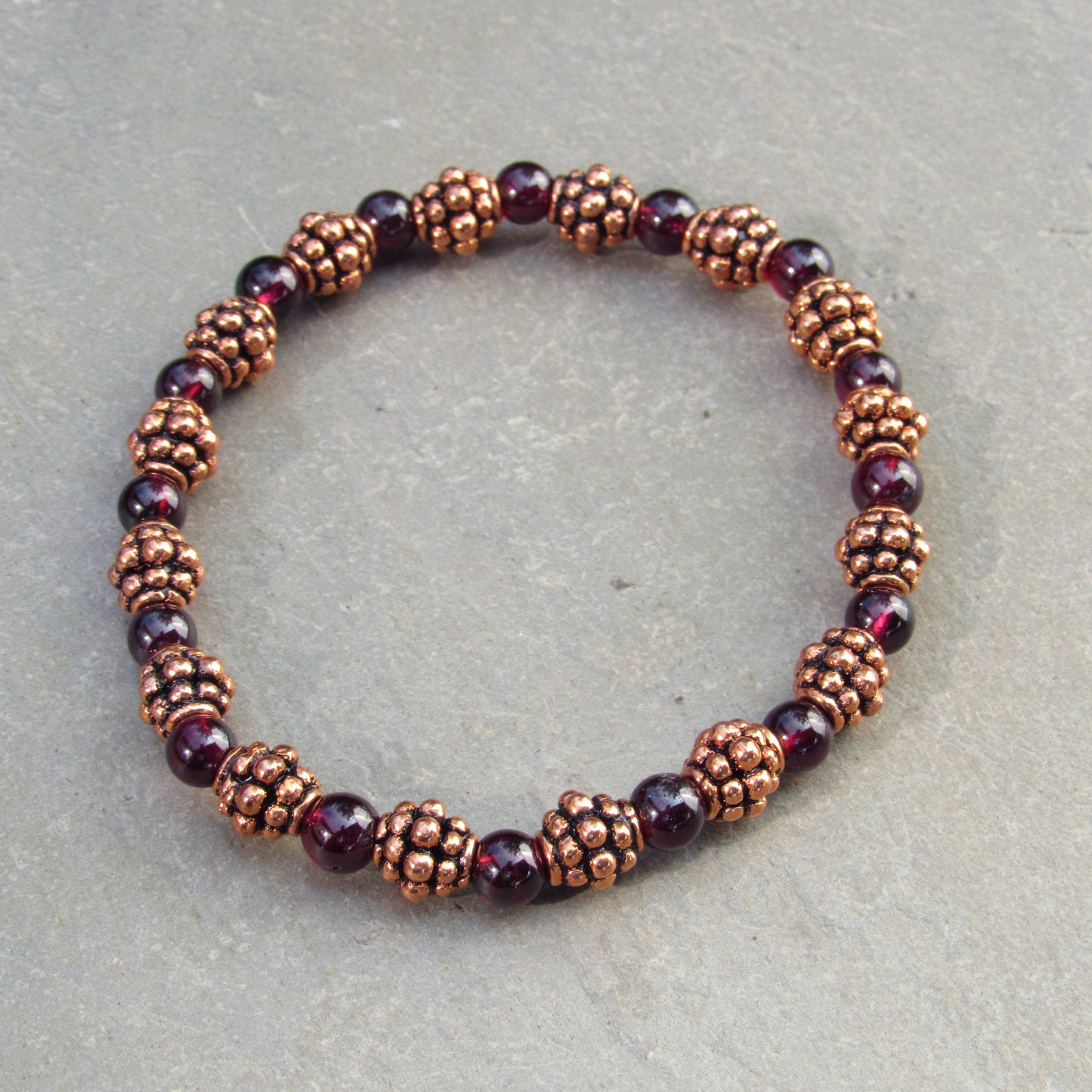 Garnet gemstones and copper bracelet