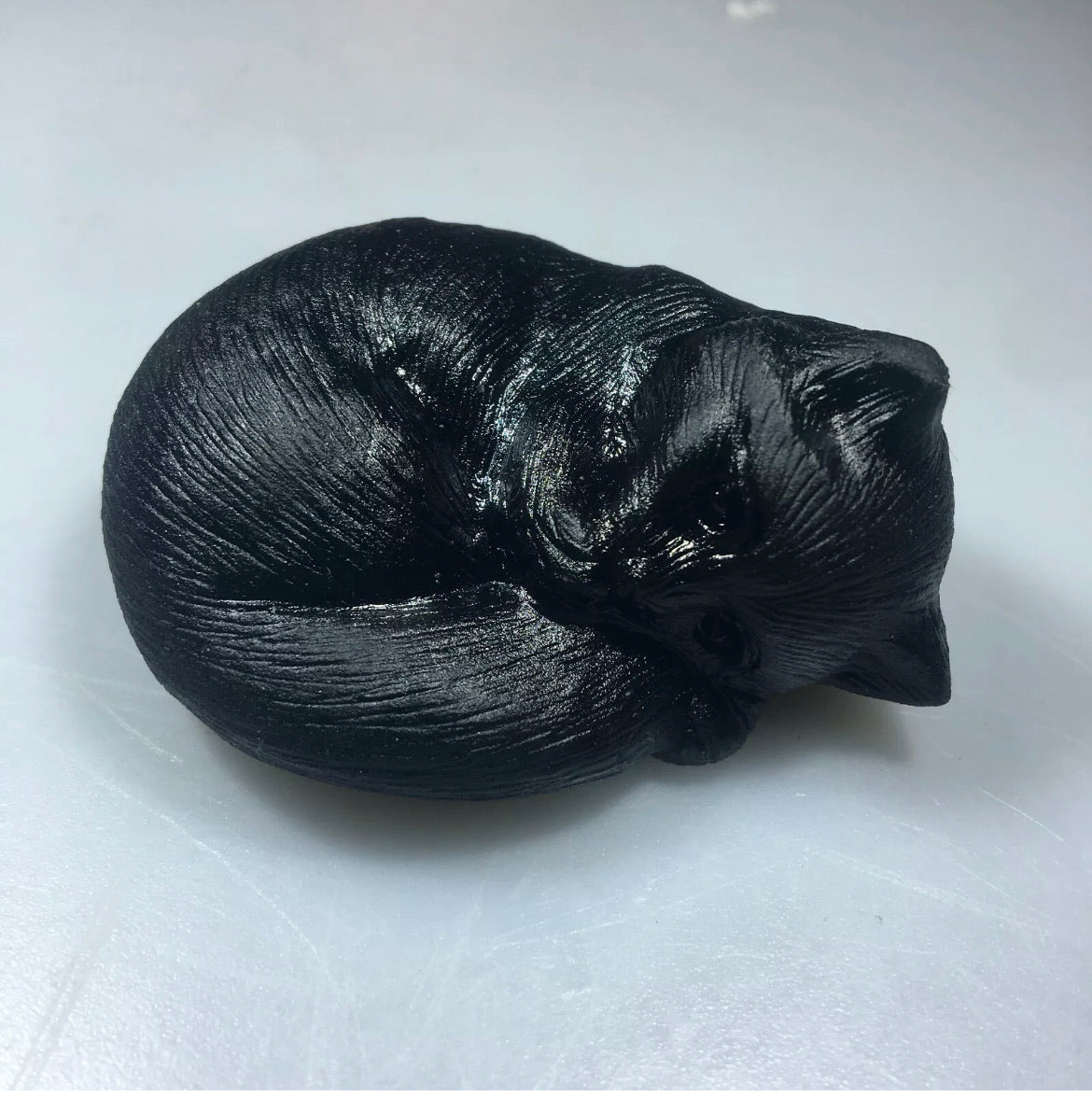 Black obsidian gemstone carved sleeping kitty cat