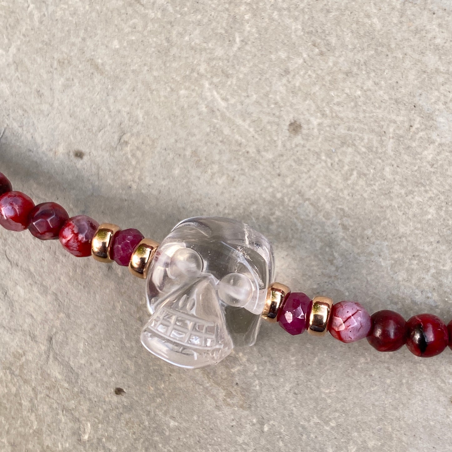 Clear quartz gemstone Skull with Rubies and fire agates and 14 kt rose gold