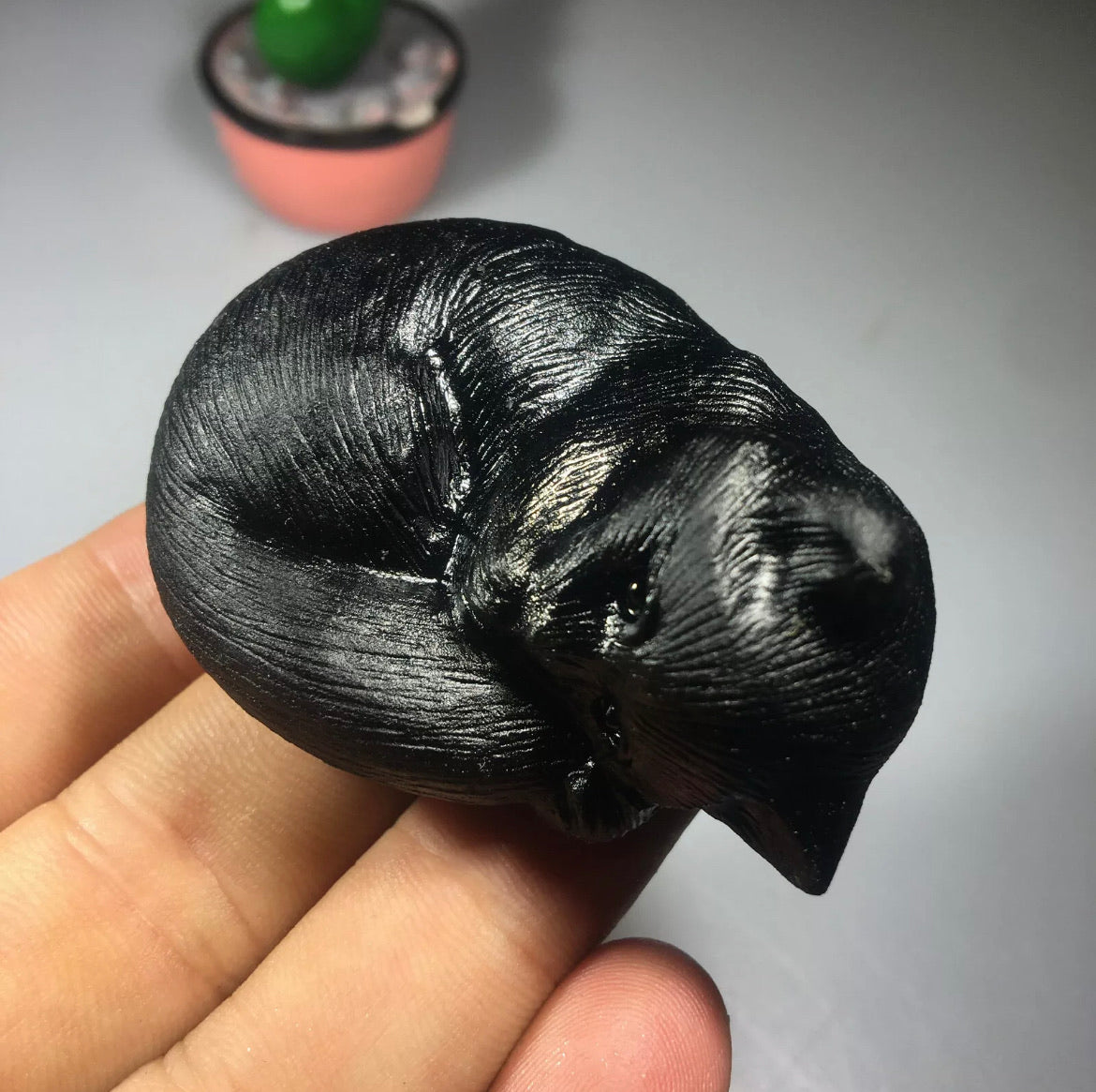 Black obsidian gemstone carved sleeping kitty cat