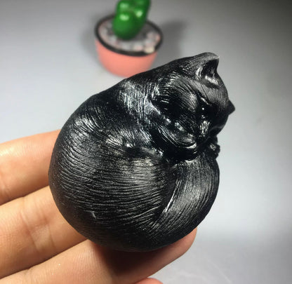 Black obsidian gemstone carved sleeping kitty cat