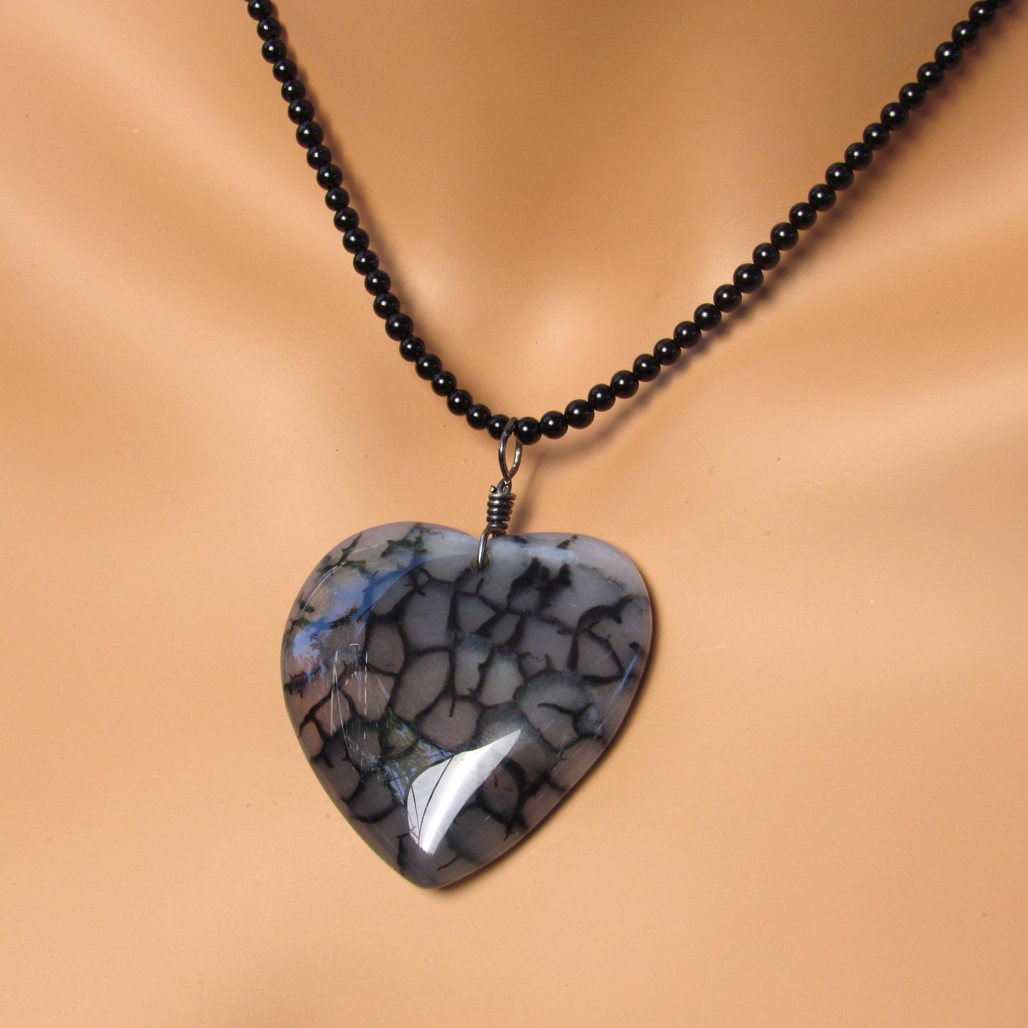 Hand Wrapped Dragon’s Vein Agate Heart on Onyx necklace with Oxidized Sterling Clasp