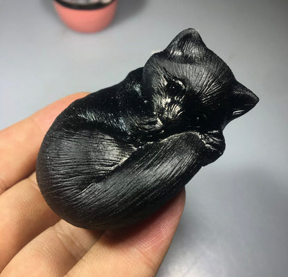 Black obsidian gemstone carved sleeping kitty cat